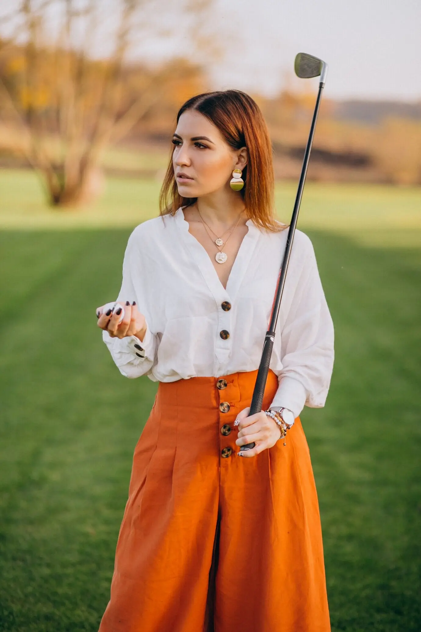 A young lady golfing.