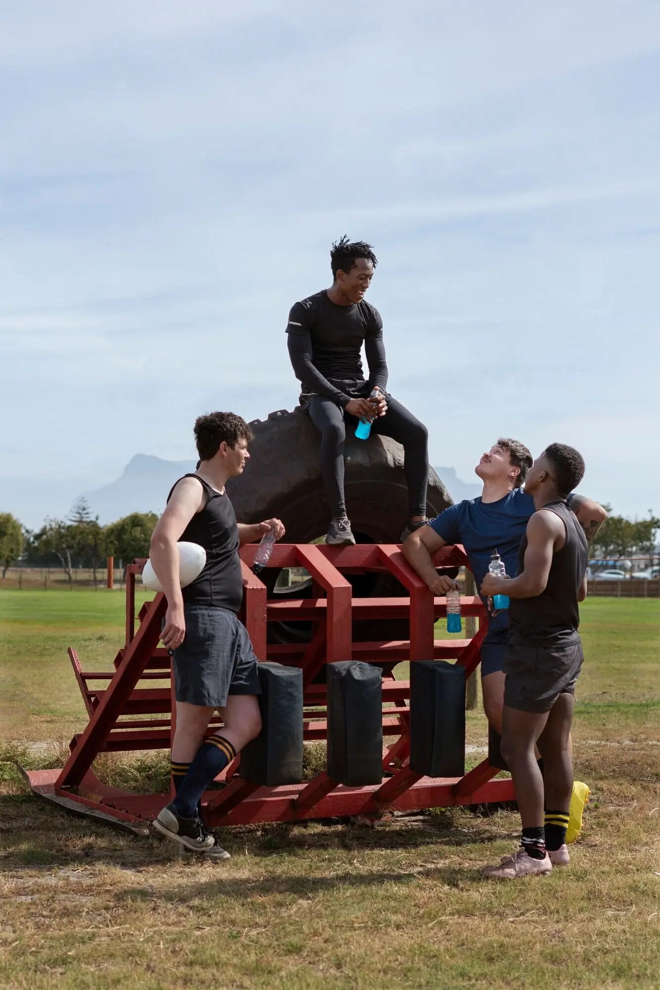 Men are playing rugby on the field.