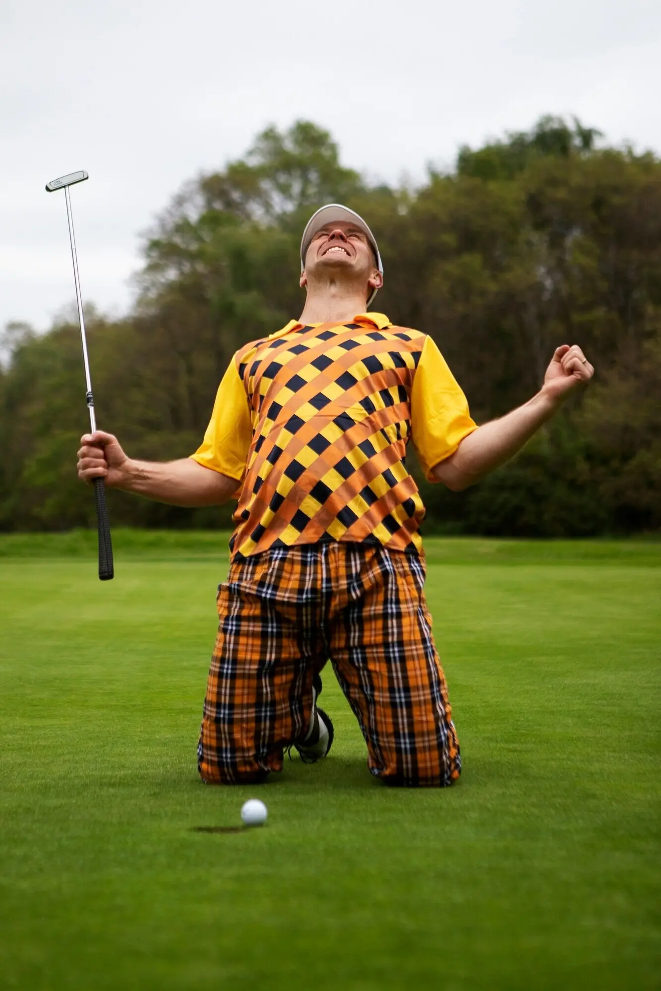 Man playing golf outdoors